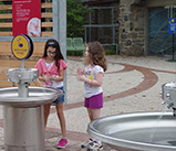 girls washing hands at outdoor hand washing station at the Philadelphia Zoo